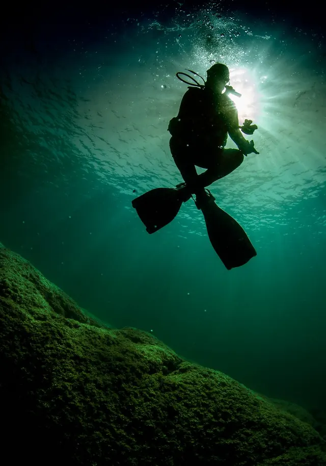 Diver silhouette underwater