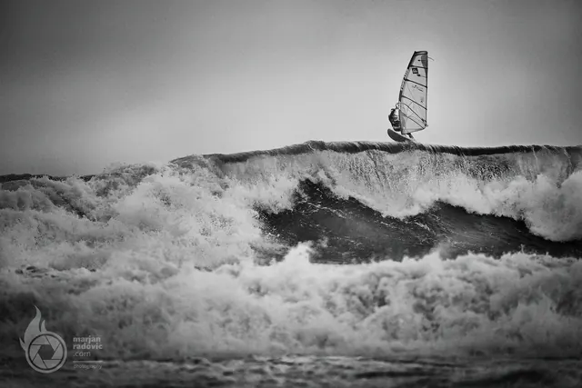 Windsurfer on a wave, black and white