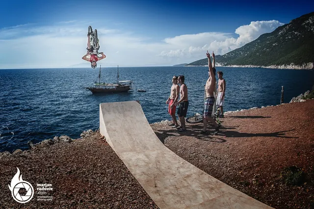 Rider flipping off a ramp into the sea